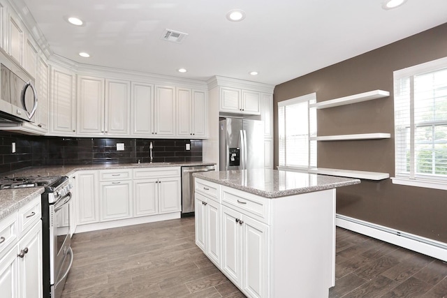 503 Jumano Ct, Suffern, NY 10901 - kitchen with stainless steel appliances, open shelves, baseboard heating, wood finished floors, and a sink