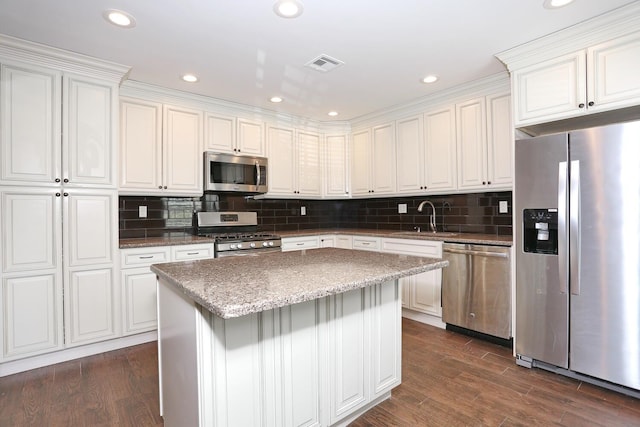 503 Jumano Ct, Suffern, NY 10901 - kitchen with appliances with stainless steel finishes, a sink, white cabinetry, backsplash, and a center island