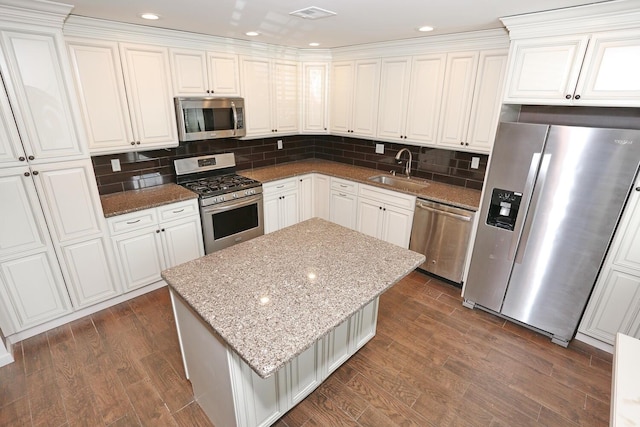 503 Jumano Ct, Suffern, NY 10901 - kitchen with stainless steel appliances, a sink, white cabinetry, light stone countertops, and recessed lighting