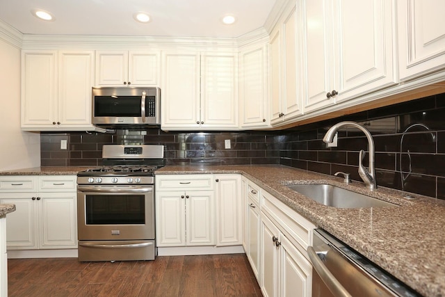 503 Jumano Ct, Suffern, NY 10901 - kitchen featuring stainless steel appliances, a sink, dark stone counters, white cabinets, and recessed lighting