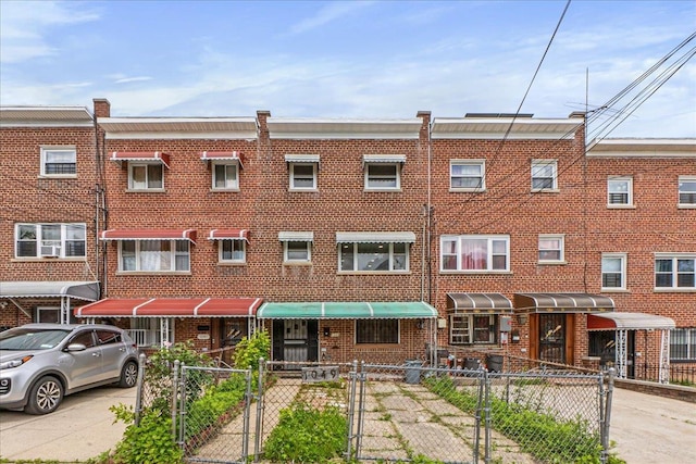 1049 E 219th St, Bronx, NY 10469 - view of front of home with brick siding, a gate, and a fenced front yard