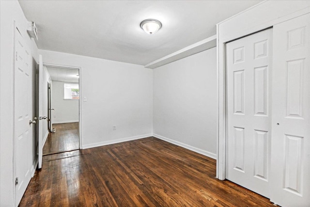 1049 E 219th St, Bronx, NY 10469 - unfurnished bedroom with dark wood finished floors and baseboards