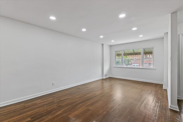 1049 E 219th St, Bronx, NY 10469 - empty room with dark wood-type flooring, recessed lighting, and baseboards