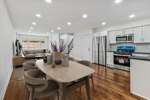 1049 E 219th St, Bronx, NY 10469 - dining area featuring dark wood finished floors, stairway, baseboards, and recessed lighting
