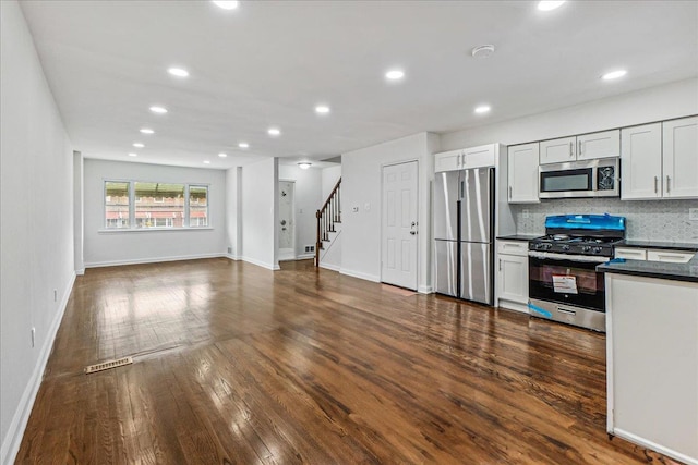 1049 E 219th St, Bronx, NY 10469 - kitchen with appliances with stainless steel finishes, dark wood finished floors, backsplash, baseboards, and recessed lighting