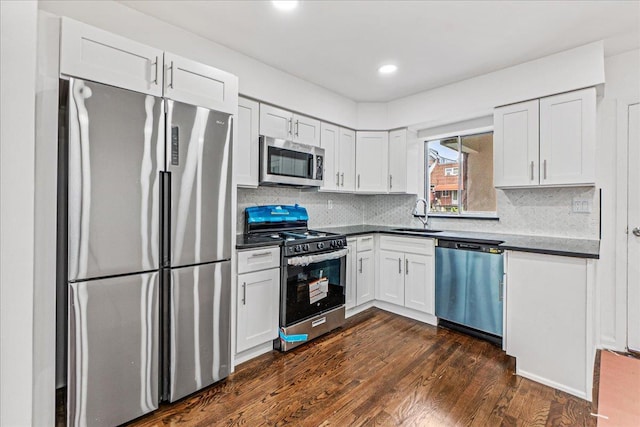 1049 E 219th St, Bronx, NY 10469 - kitchen with appliances with stainless steel finishes, a sink, dark wood-style floors, tasteful backsplash, and recessed lighting
