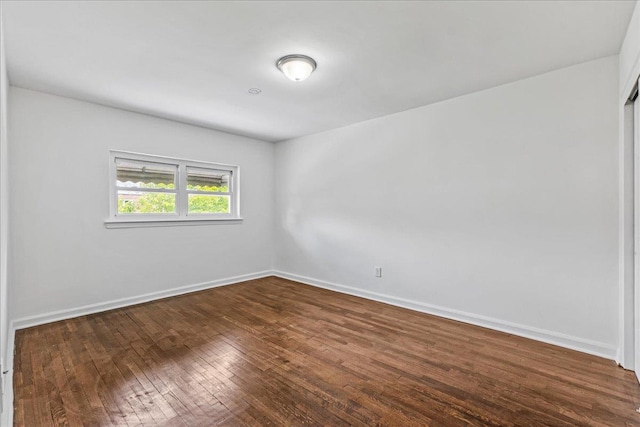 1049 E 219th St, Bronx, NY 10469 - empty room featuring dark wood-type flooring and baseboards