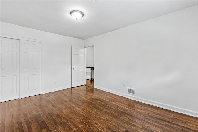 1049 E 219th St, Bronx, NY 10469 - unfurnished bedroom with baseboards, wood finished floors, and a closet