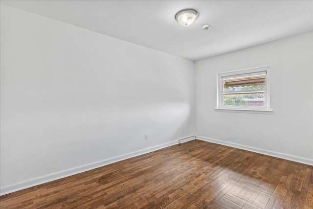 1049 E 219th St, Bronx, NY 10469 - unfurnished room featuring dark wood-type flooring and baseboards