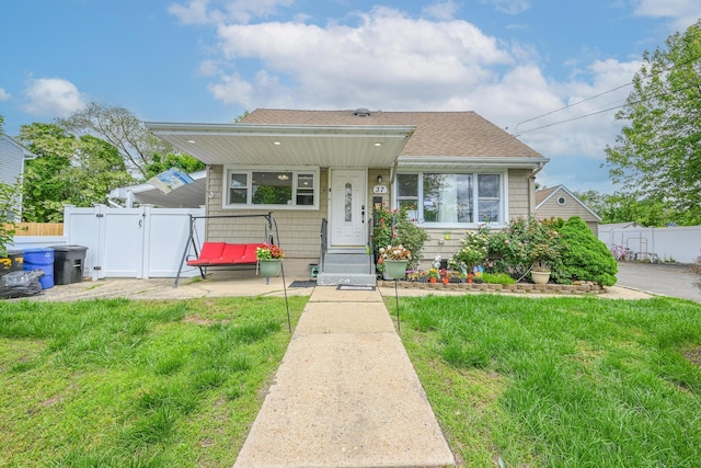 37 E Locust St, Central Islip, NY 11722 - bungalow-style house featuring a gate, roof with shingles, and entry steps