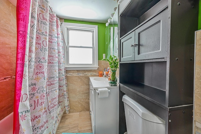 37 E Locust St, Central Islip, NY 11722 - full bathroom with vanity, a shower with shower curtain, tile walls, a wainscoted wall, and toilet