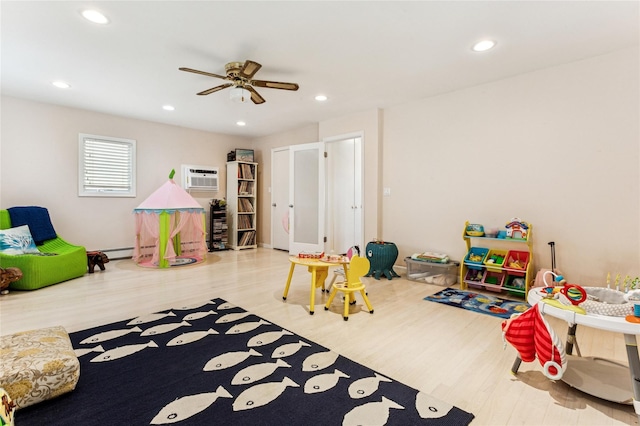 931A Oceanfront St, Long Beach, NY 11561 - recreation room featuring wood finished floors, ceiling fan, recessed lighting, and a wall unit AC