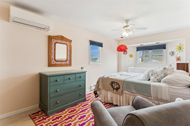 931A Oceanfront St, Long Beach, NY 11561 - bedroom featuring a wall unit AC, light wood-style flooring, ceiling fan, and baseboard heating