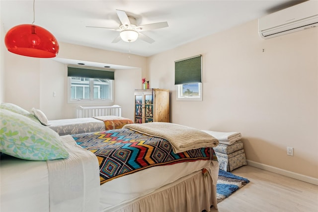 931A Oceanfront St, Long Beach, NY 11561 - bedroom with a wall mounted AC, wood finished floors, radiator heating unit, and a ceiling fan