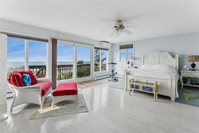 931A Oceanfront St, Long Beach, NY 11561 - bedroom featuring a wall mounted air conditioner, access to exterior, a water view, wood finished floors, and ceiling fan