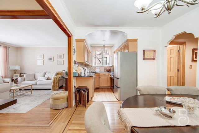 46-10 28th Ave, Astoria, NY 11103 - living area featuring a chandelier, arched walkways, light wood finished floors, and ornamental molding