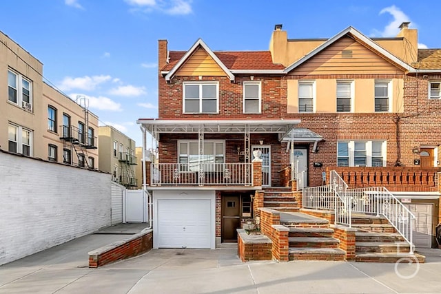 46-10 28th Ave, Astoria, NY 11103 - multi unit property featuring a chimney, brick siding, a garage, driveway, and stairs