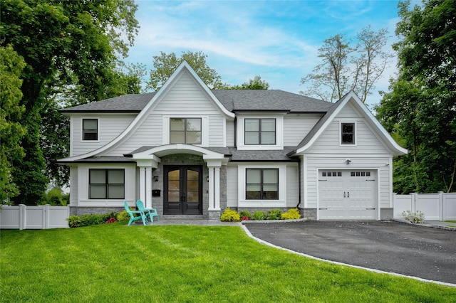 9 Wyndham Way, Port Washington, NY 11050 - view of front of home with french doors, asphalt driveway, a shingled roof, stone siding, and a garage