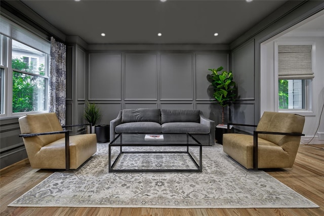 9 Wyndham Way, Port Washington, NY 11050 - living room featuring a decorative wall, wood finished floors, and recessed lighting