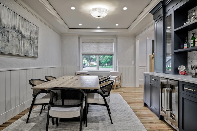 9 Wyndham Way, Port Washington, NY 11050 - dining space featuring wine cooler, a wainscoted wall, ornamental molding, light wood-type flooring, and a bar