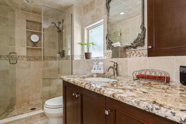 2432 Cadillac Dr, East Meadow, NY 11554 - bathroom featuring tile walls, a stall shower, vanity, toilet, and decorative backsplash