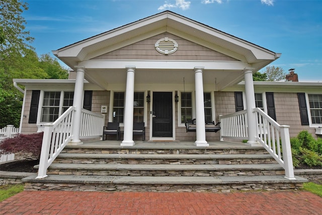 213 Glenwood Ln, Port Jefferson, NY 11777 - view of front of property with a porch and a chimney