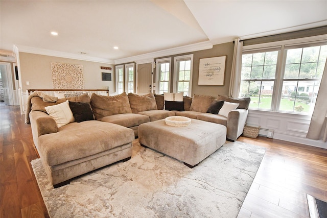 213 Glenwood Ln, Port Jefferson, NY 11777 - living area featuring crown molding, healthy amount of natural light, wood finished floors, a baseboard heating unit, and recessed lighting