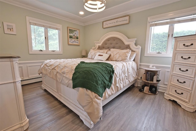 213 Glenwood Ln, Port Jefferson, NY 11777 - bedroom with a baseboard heating unit, multiple windows, wood finished floors, ornamental molding, and wainscoting