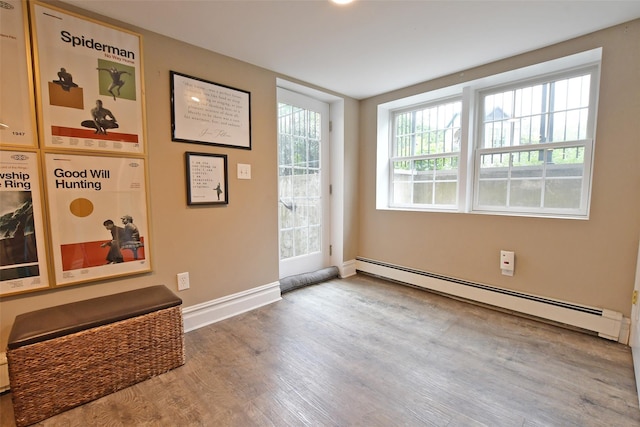 213 Glenwood Ln, Port Jefferson, NY 11777 - foyer entrance with baseboard heating, wood finished floors, and baseboards