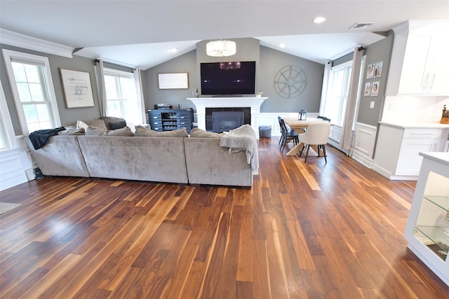 213 Glenwood Ln, Port Jefferson, NY 11777 - living room with lofted ceiling, dark wood-type flooring, and a glass covered fireplace