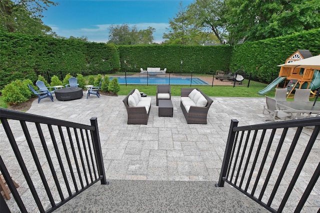 213 Glenwood Ln, Port Jefferson, NY 11777 - view of patio featuring a playground and an outdoor living space with a fire pit