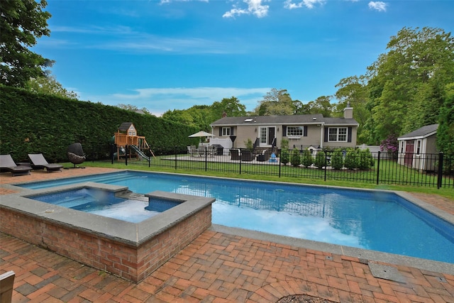 213 Glenwood Ln, Port Jefferson, NY 11777 - view of swimming pool with a playground, an in-ground hot tub, and a patio area