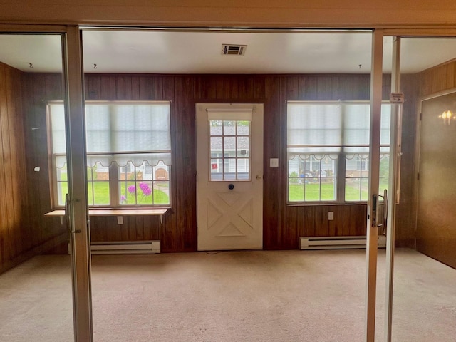 404B Woodbridge Dr Unit 404B, Ridge, NY 11961 - entryway with baseboard heating, carpet flooring, and wooden walls