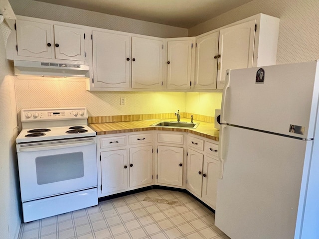 404B Woodbridge Dr Unit 404B, Ridge, NY 11961 - kitchen with white appliances, a sink, under cabinet range hood, and white cabinets