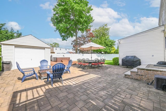 943 Durham Rd, East Meadow, NY 11554 - fenced backyard featuring outdoor dining space, grilling area, a hot tub, a patio area, and an outdoor structure