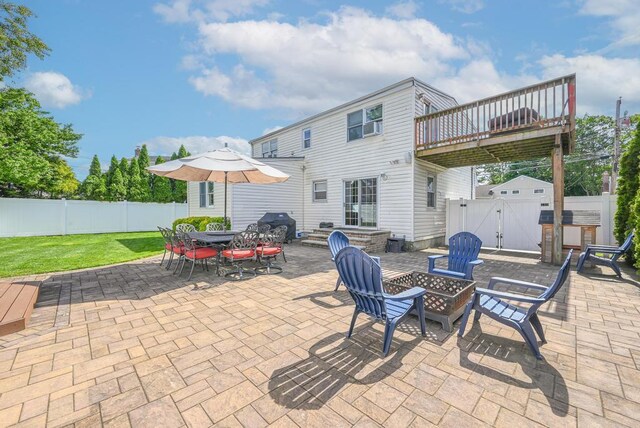 943 Durham Rd, East Meadow, NY 11554 - fenced backyard featuring a gate, an outdoor fire pit, a patio area, and a wooden deck