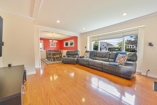 943 Durham Rd, East Meadow, NY 11554 - living room with ornamental molding, a chandelier, baseboards, light wood-style flooring, and recessed lighting