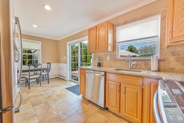 943 Durham Rd, East Meadow, NY 11554 - kitchen featuring stainless steel appliances, a sink, ornamental molding, decorative backsplash, and a wainscoted wall