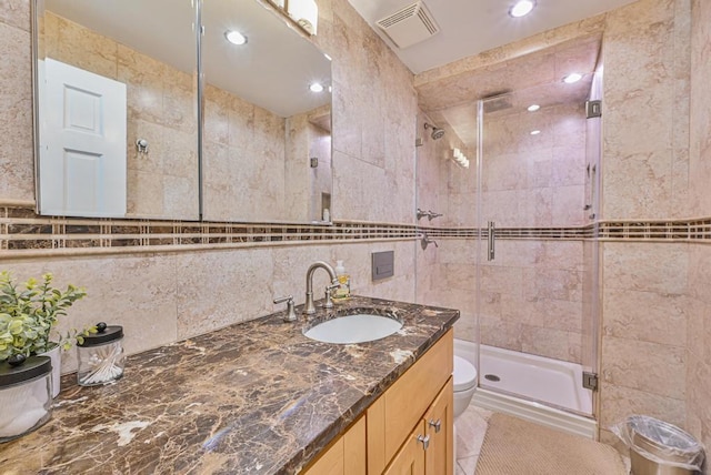 943 Durham Rd, East Meadow, NY 11554 - bathroom featuring tile walls, vanity, a shower stall, toilet, and decorative backsplash