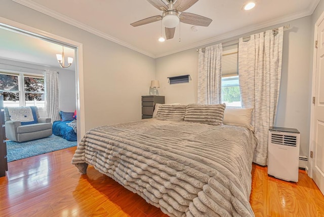 943 Durham Rd, East Meadow, NY 11554 - bedroom featuring wood finished floors, recessed lighting, crown molding, a baseboard radiator, and ceiling fan