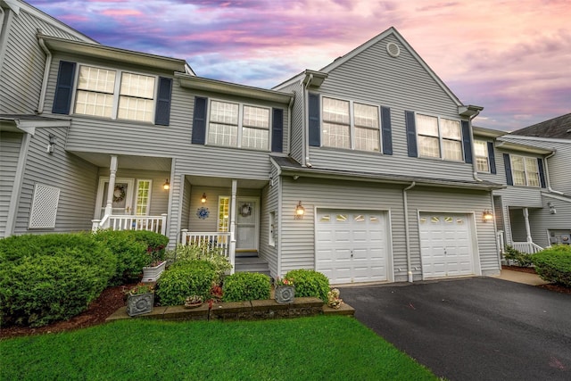 5005 John Hancock Ct Unit 100, New Windsor, NY 12553 - view of property featuring a porch, driveway, and a garage