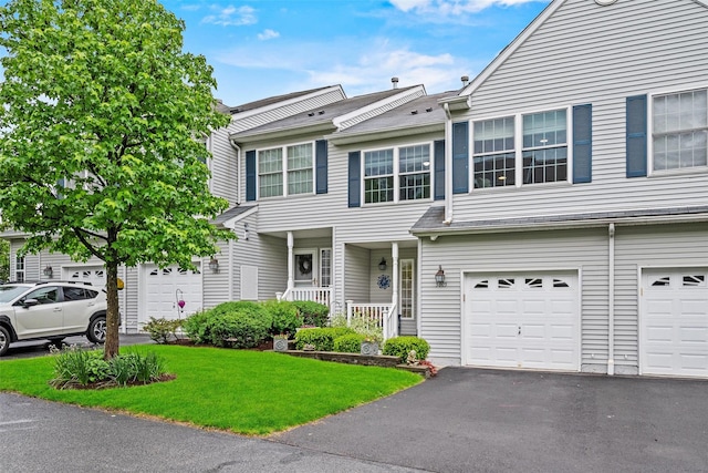 5005 John Hancock Ct Unit 100, New Windsor, NY 12553 - townhome / multi-family property featuring driveway, an attached garage, a front lawn, and a porch