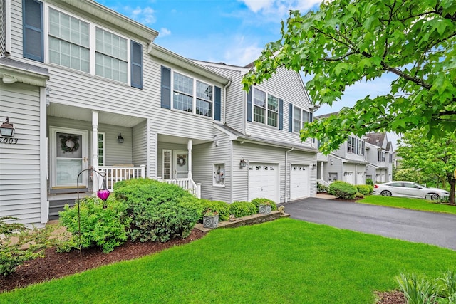 5005 John Hancock Ct Unit 100, New Windsor, NY 12553 - view of property featuring a porch, driveway, a front yard, and a garage