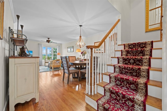 5005 John Hancock Ct Unit 100, New Windsor, NY 12553 - staircase with wood finished floors, a chandelier, ceiling fan, and crown molding