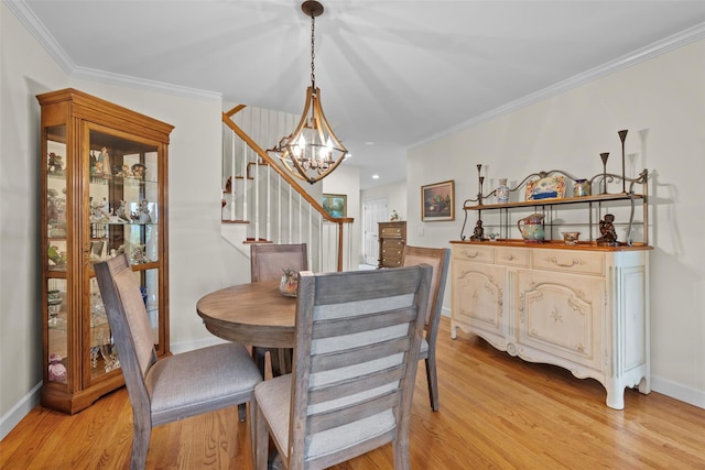 5005 John Hancock Ct Unit 100, New Windsor, NY 12553 - dining space with light wood-style flooring, stairs, a chandelier, ornamental molding, and baseboards