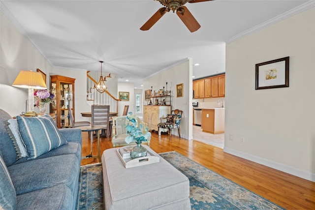 5005 John Hancock Ct Unit 100, New Windsor, NY 12553 - living room featuring stairway, crown molding, light wood finished floors, ceiling fan, and a chandelier