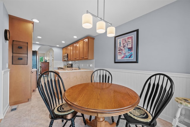 5005 John Hancock Ct Unit 100, New Windsor, NY 12553 - dining area with arched walkways, a wainscoted wall, and recessed lighting