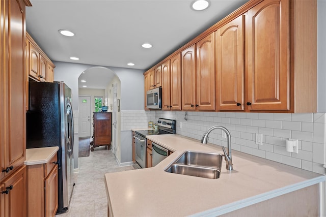 5005 John Hancock Ct Unit 100, New Windsor, NY 12553 - kitchen featuring a sink, appliances with stainless steel finishes, arched walkways, light countertops, and recessed lighting