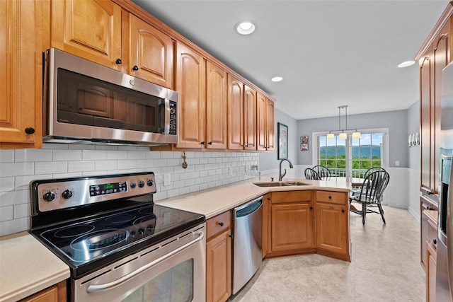 5005 John Hancock Ct Unit 100, New Windsor, NY 12553 - kitchen with stainless steel appliances, a sink, a peninsula, light countertops, and recessed lighting
