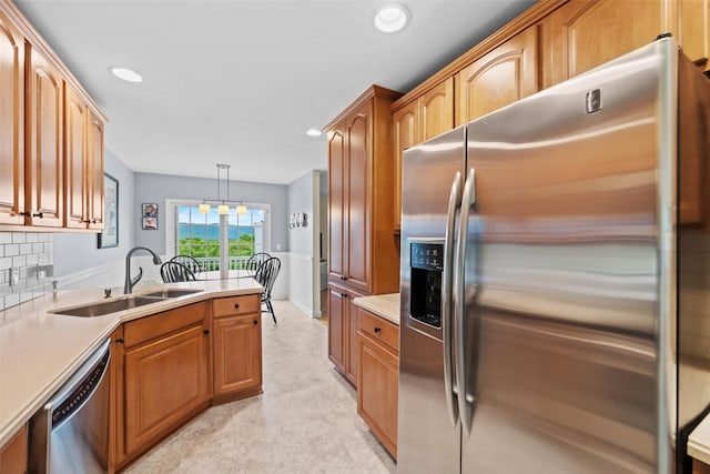 5005 John Hancock Ct Unit 100, New Windsor, NY 12553 - kitchen featuring stainless steel appliances, a sink, recessed lighting, light countertops, and decorative backsplash